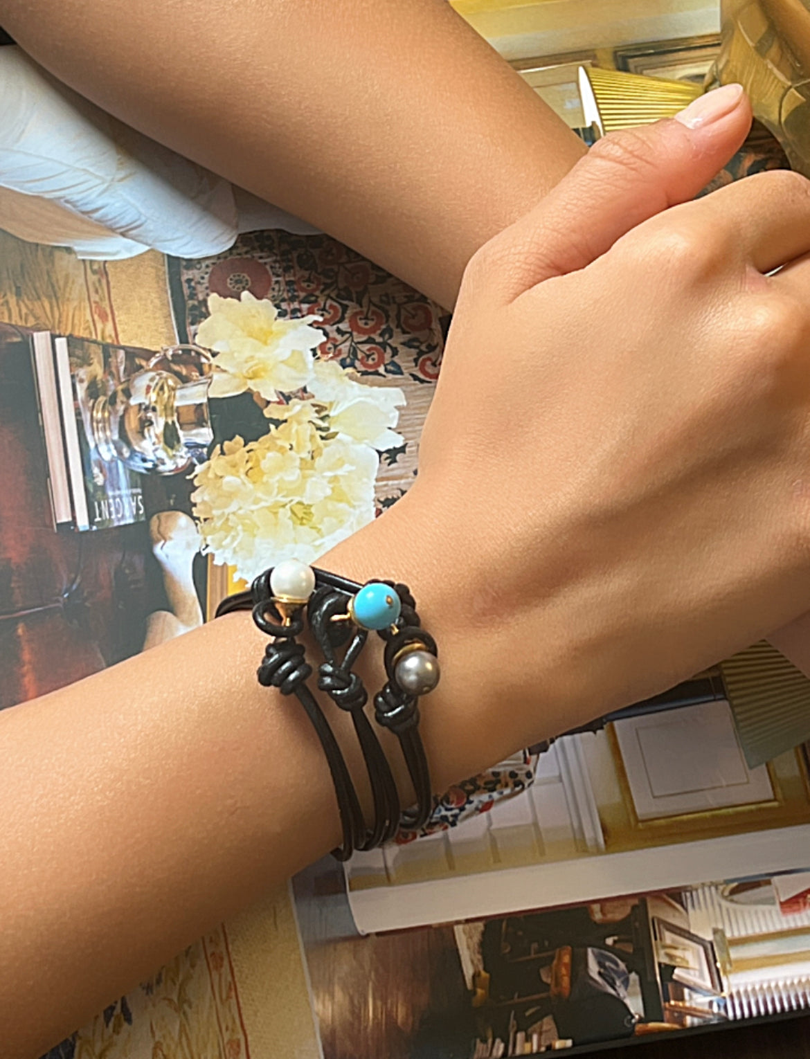 Model with three Teeny black leather bracelets