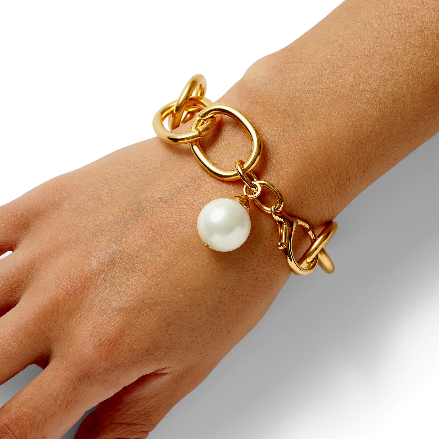 model with big boy bracelet in gold with white pearl  